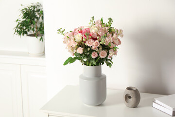 Beautiful bouquet of fresh flowers in vase on white table indoors