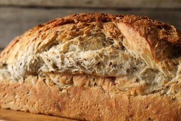 Freshly baked sourdough bread on wooden table, closeup