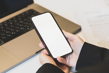 girl holding a smartphone in her hands in the office close up