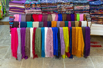 Colorful fashion stylish scarves sold outside on a market - 795627317