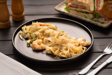 Pasta with Shrimp and Cream Sauce on black plate, Mediterranean Food. Italian Cuisine concept