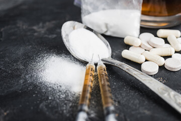 Narcotic substances in spoon, dope powder in transparent plastic bag, syringes with drugs dose,...