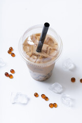 Plastic glass with bubble tea and ice. Trendy summer drink on white background