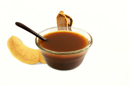 Tamarind fruit with tamarind water concentrate chutney pulp or paste for indian gujarati food panipuri,golgappa,rasam,dal,soup,chutny,paste,sarbat on white background