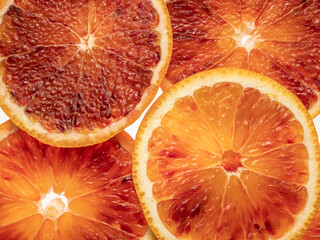 Red blood orange fruit slices on white background. Close up.
