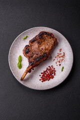 Delicious juicy beef steak on the bone, tomahawk with salt, spices and herbs