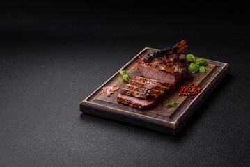 Delicious juicy beef steak on the bone, tomahawk with salt, spices and herbs