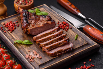 Delicious juicy beef steak on the bone, tomahawk with salt, spices and herbs