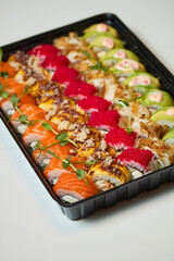 Sushi roll Philadelphia with salmon, smoked eel, avocado, cream cheese on black background. Sushi menu. Japanese food.