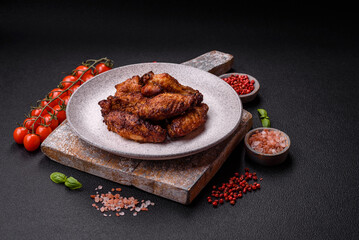 Delicious juicy chicken wings baked on the grill with salt, spices and herbs