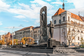Lviv, Ukraine - November 2, 2023: Monument to Taras Shevchenko on Svobody Avenue in Lviv against the backdrop of ancient urban development. Beautiful cityscape on a sunny autumn day