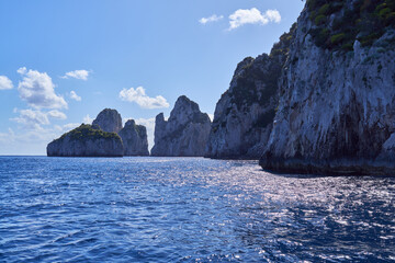 The coastline of the island of  Capri, with Faraglioni di Capri rock formations in the background,...