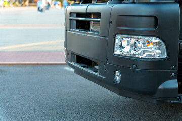A new truck with a trailer on the road. Details of the truck in close-up. New headlights and wheels...