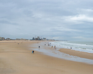 Oostende, Belgium - July 31st: Few people on the wide beach during evening hours in nasty weather