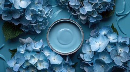 Top-down view of an open paint can in Serenity, a soft blue shade, surrounded by blue hydrangeas...