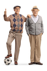 Elderly men standing with a football and gesturing thumbs up