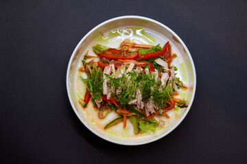 A white plate with a vegetable salad, a staple food on the table