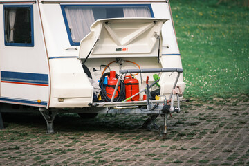 there are 2 gas cylinders in the storage space of a caravan