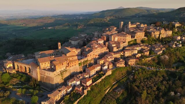 Aerial shot of medieval town of Montepulciano at sunset, Siena, Italy. Flying over Montepulciano old village in Tuscany