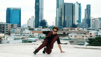 Professional asian break dancer practice B boy dance while multicultural friends at roof top. Young...