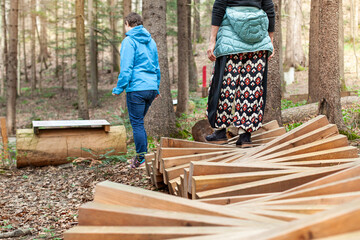Personen laufen auf Holzstamm im Wald. Motorisches Bewegungskonzept in der Natur....