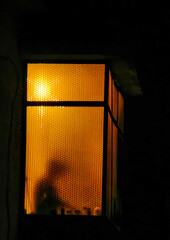 Shadowed Secrets. The Enigma Behind the Window Frame. Orange color light. Mystery in the box.