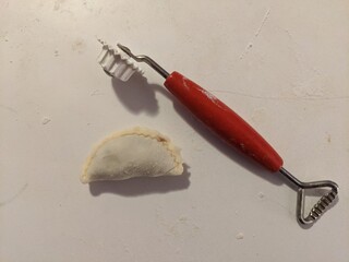 Making homemade pierogies using tools on the kitchen countertop