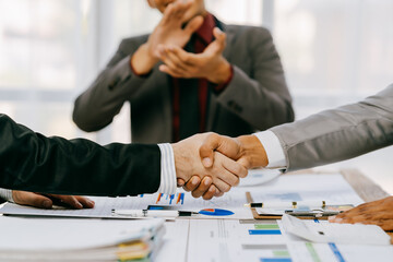 Business people shake hands with business partners at a meeting. The concept of organizational dispute settlement.