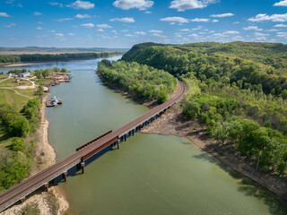 Gasconade River at confluence with the Missouri River, springtime aerial view with a railroad bridge and old boatyard