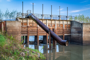 gates and pump station on a channel in a valley of Missouri river near Peru, Nebraska - 795730378