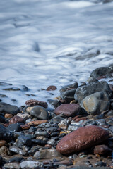 TEXTURE SET OF STONES ON THE SHORE FILED BY THE SEA WAVES