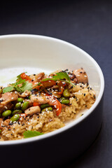 A plate of rice and vegetables on a table, a staple food dishware in cuisine