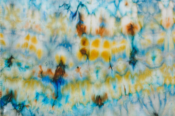 abstract pattern on silk fabric texture in blue, yellow, green colors