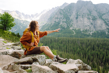 Portrait of a successful tourist on the mountain and enjoying freedom. Concept of trekking, active...