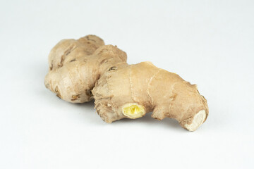 Raw fresh uncut ginger root on white background