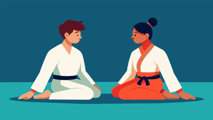 During a break in their training two martial artists sit crosslegged on the floor their eyes locked in a staring contest as they practice their