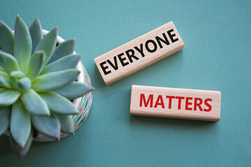 Everyone matters symbol. Concept words Everyone matters on wooden blocks. Beautiful grey green...