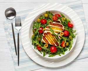 salad with grilled halloumi greek cheese in bowl