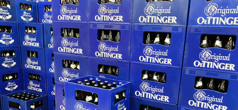 Viersen, Germany - May 9. 2024: Closeup of large stack Oettinger blue beer crates in german store