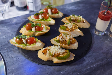 light snacks for the holiday, catering. Various light snacks. Catering plate. Assortment of sandwiches on the buffet table. meat, fish, vegetable canapes.