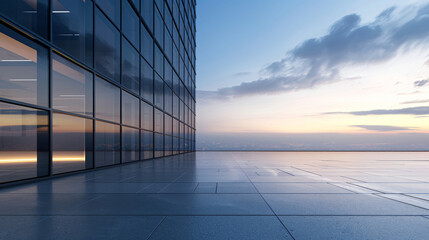 Fototapeta premium Contemporary skyscraper with glass facade against urban skyline at dusk