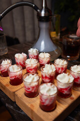 Group cheers with shot glasses of Paulaner hefeweizen wheat beer at fun event