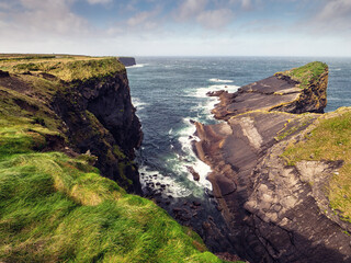 Kilkee cliff in county Clare, Ireland. Popular travel area with stunning nature scenery with green...