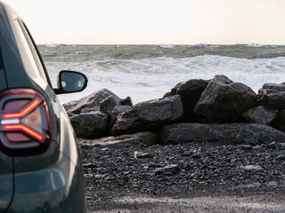 Car parked close to the ocean with view on amazing nature scene with powerful waves. Doolin area,...