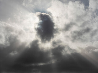 Dark dramatic storm sky background with rays of light. Nature background for design and sky...