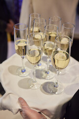 Table with champagne stemware and man in background at event