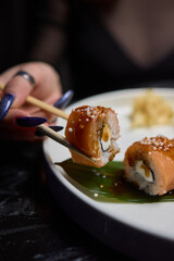 Sushi dish on white plate with sauce, table setting