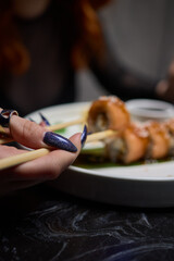 Sushi dish on white plate with sauce, table setting