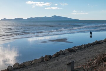 The beach shoreline of Paekakariki. In the background is Kapiti Island. Wellington, New Zealand.