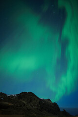 Night Sky with Colorful Aurora above Mountains in Southern Iceland